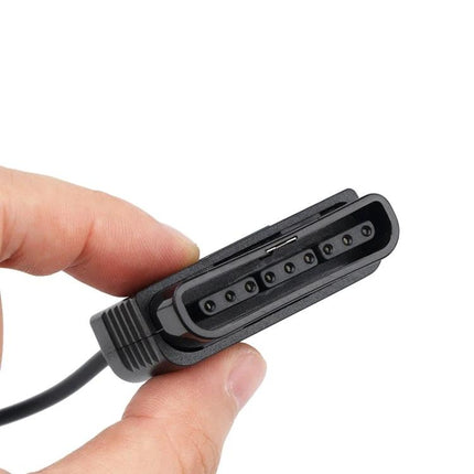 Kebidu Adapter for PS2 Controllers in Home Gaming Use held between fingers showing PS2 connector for PS3 and PC compatibility