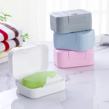 A Compact Soap Box for Travel and Everyday Storage at Home - plastic travel soap case in white with green soap and stacked gray blue pink boxes