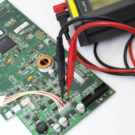 Test Probe for Electrical Testing and Auto Repair Tools measuring voltage on a circuit board with red and black leads