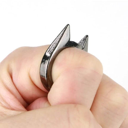 Stainless Steel Self-Defense Ring for Everyday Personal Safety shown worn on thumb with pointed stainless steel prongs for discreet protection