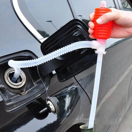 Red Manual Siphon Pump for Transferring Gas and Oil in Vehicles shown siphoning fuel from a car tank with red hand pump