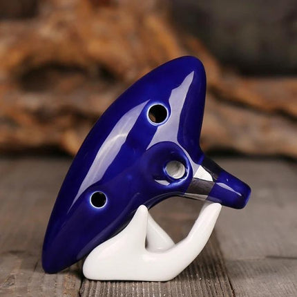 Ocarina for Beginner Musicians to Enjoy Music at Home - glossy blue ceramic ocarina on white stand for casual home practice