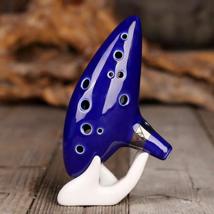 Ocarina for Beginner Musicians to Enjoy Music at Home - blue glazed ceramic ocarina on white stand for casual home practice