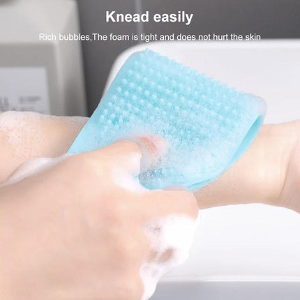 A Silicone Bath Brush for Everyday Skin Care Routines - blue silicone exfoliating scrubber creating foam for gentle back and body cleansing
