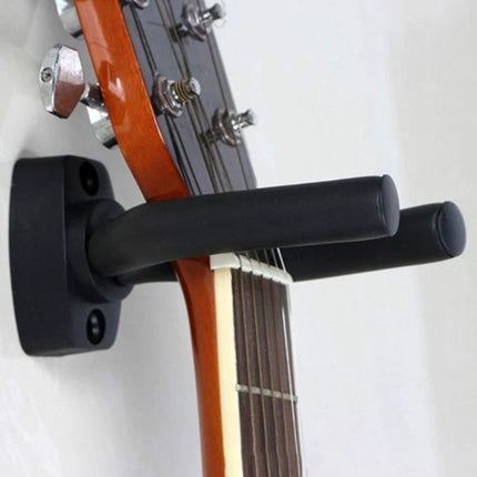 Wall Hook for Hanging Guitars and Ukuleles in Home Spaces — black metal wall mount holding acoustic guitar headstock securely