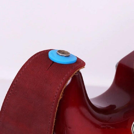 Keeps Guitar Strap Secure for Everyday Music Sessions with blue silicone ring on red leather strap and electric guitar