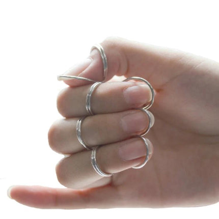 Durable Metal Spring Ring For Everyday Guitar Practice Sessions - silver finger support rings shown on hand reducing discomfort during strumming