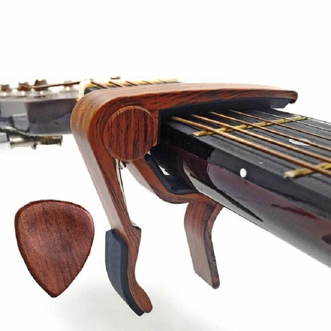 Essential Wooden Guitar Capo and Picks for Daily Practice wooden capo clamped on guitar neck with matching wood pick