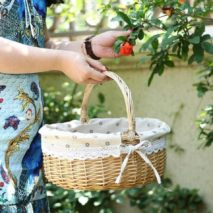 Hand Woven Picnic Basket Sackcloth Rattan Storage Basket Small held by person picking a flower, removable washable lining, natural wicker for picnics and home storage
