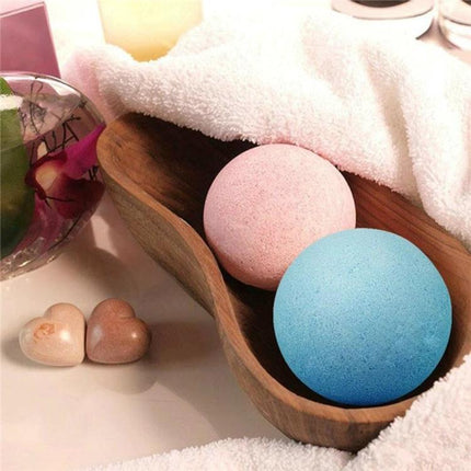 Set of Colorful Bath Bombs for Everyday Home Relaxation - two pastel bath bombs in wooden tray with towel and spa decor