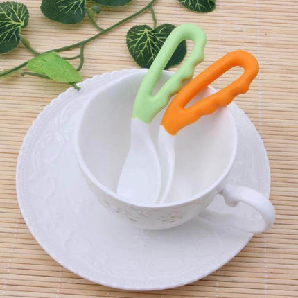 Baby Curved Feeding Spoon Set 2 Pack For Easy Feeding - two curved PP baby spoons in green and orange in a white cup for neat early solids feeding