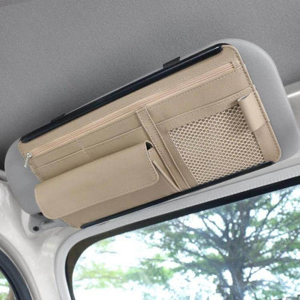 Car Sun Visor Organizer Case With Zipper For Glasses And Cards neatly attached to visor holding phone, wallet, glasses, cards and change in beige PU leather