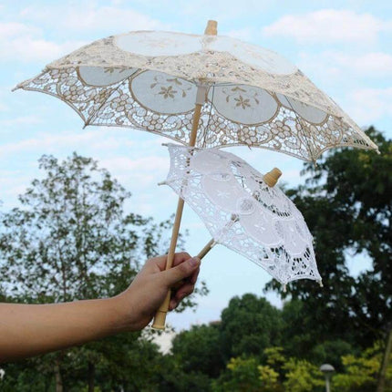 Elegant Bridal Lace Umbrella for Weddings and Photo Sessions held outdoors showing lace canopy and wooden handle