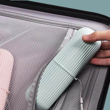 Travel Toothbrush Storage Cup With Two Mouthwash Cups compact pastel travel case held by hand in suitcase mesh pocket
