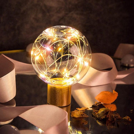 Ambient Star and Moon Night Light for Relaxing Home Evenings glowing glass orb on wooden base with soft LED fairy lights for calming bedtime ambiance