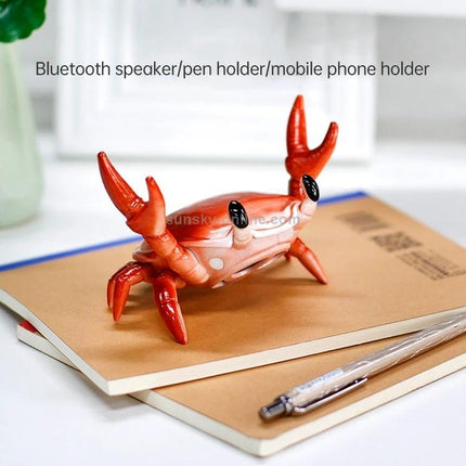 Crab-Style Mobile Phone Stand with Bluetooth Speaker and Pen Holder on desk holding phone and pen, red crab design for hands-free streaming