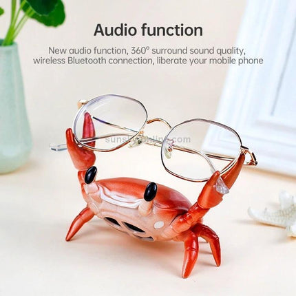 Crab-Style Mobile Phone Stand with Bluetooth Speaker and Pen Holder holding glasses on desk, Bluetooth speaker and pen organizer in fun crab design