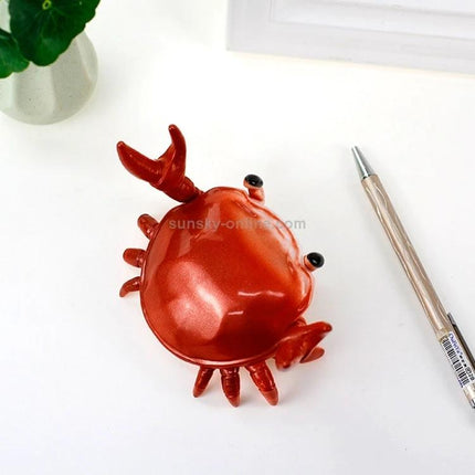 Crab-Style Mobile Phone Stand with Bluetooth Speaker and Pen Holder on desk, red crab-shaped holder showing pen slot and speaker