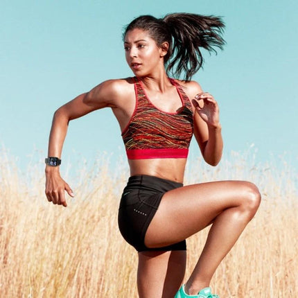 Smart Bracelet for Everyday Health and Activity Tracking on woman running outdoors monitoring heart rate and using NFC-enabled wrist device