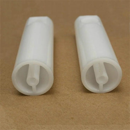 Handy Tool for Routine Vehicle Fuel System Maintenance at Home - close-up of two white plastic fuel injector cleaning adapters