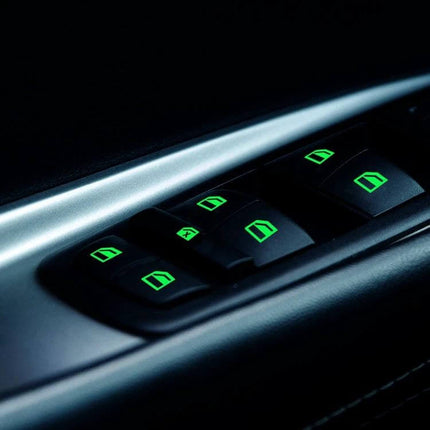 Luminous Car Window Switch Sticker for Nighttime Use glowing green paper decal on car power window controls for easy visibility in low light