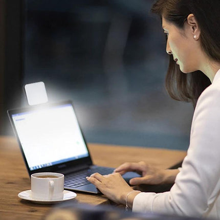 Light for Everyday Video Calls and Home Office Use LED clip-on lamp illuminating a laptop and face during virtual meeting