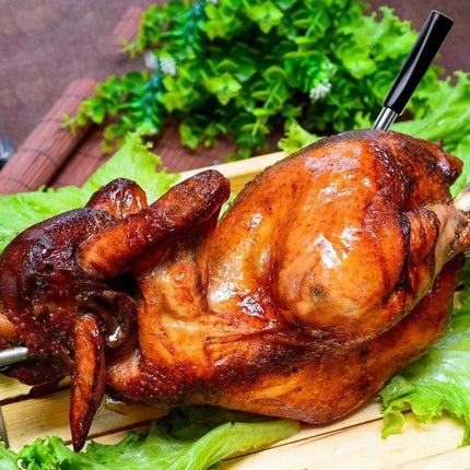 Wireless Bluetooth BBQ Probe Thermometer For Grilling With App inserted into roasted whole chicken on lettuce for cord-free temperature monitoring