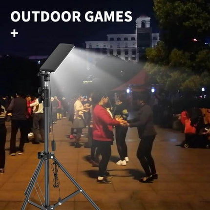 Portable Camping Lamp With Adjustable Bracket For Outdoors illuminating a night outdoor games scene on tripod with 84 LED bright white light