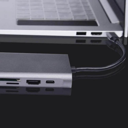 Type-C Multi-Function Docking Station for Charging and Connecting shown connected to a laptop with HDMI, USB and card reader ports