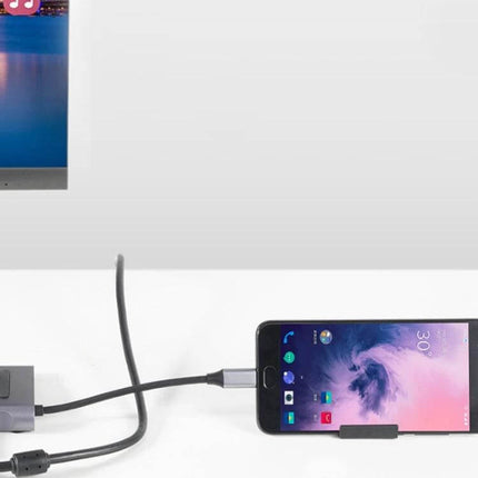 Type-C Multi-Function Docking Station for Charging and Connecting showing phone and monitor connected via USB-C hub with three USB3.0 ports