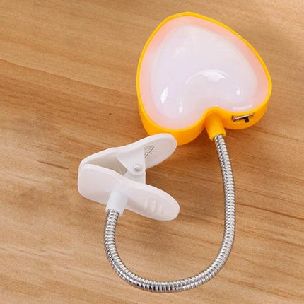 Heart-Shaped Clip Light for Evening Reading and Study clipped to book with flexible neck, reduces eye strain for late-night study