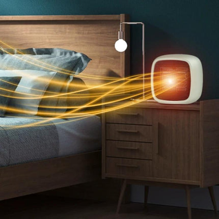 Compact Portable Electric Heater for Indoor Home Warming on bedside table blowing warm air across a small bedroom