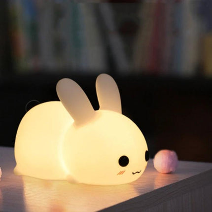 Soft Rabbit Night Light for Children's Bedtime Routines on a nightstand, soft silicone glow comforting children during bedtime