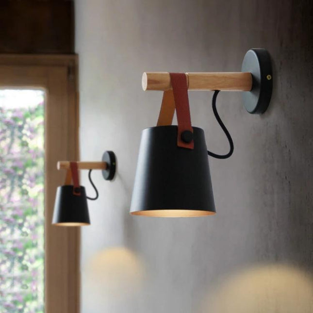 Wooden Wall Lamp for Everyday Bedroom Lighting Needs mounted beside bed with black shade, wood arm and leather strap, downward reading light