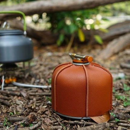 Outdoor PU Gas Tank Protective Cover For 230g And 450g Tanks shown on brown PU cover protecting gas canister at campsite