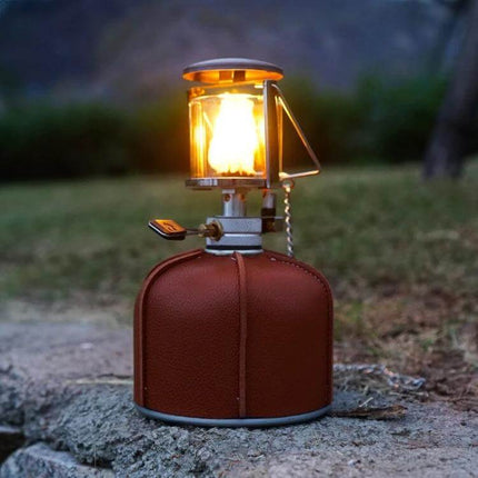 Outdoor PU Gas Tank Protective Cover For 230g And 450g Tanks on a camping gas canister with lit lantern, PU brown protective sleeve for outdoor use