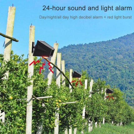 Wireless Solar Motion Sensor Alarm with Sound and Light mounted on orchard posts emitting red light and 129dB alarm to protect farm perimeter