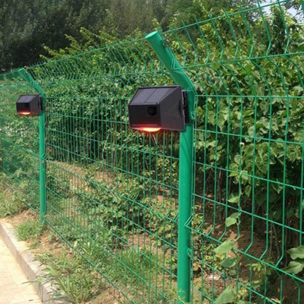 Wireless Solar Motion Sensor Alarm with Sound and Light mounted on outdoor fence detecting motion and flashing LED 129dB deterrent