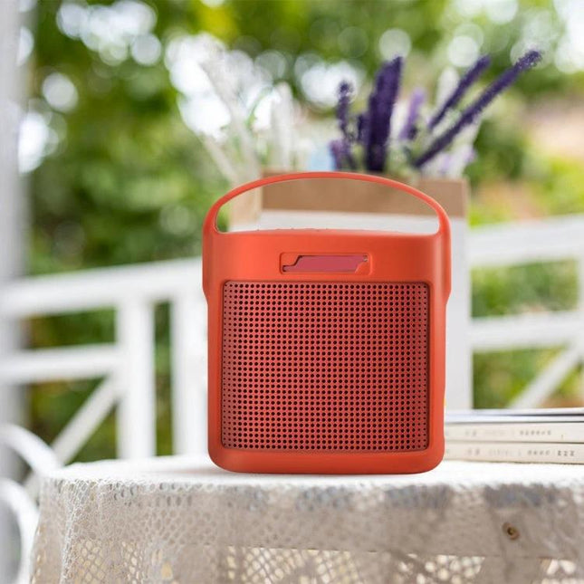 Bose Silicone Protective Cover For Portable Speaker Daily Travel in orange with carabiner clipped for commuting and outdoor use
