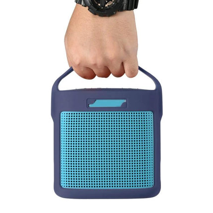Bose Silicone Protective Cover For Portable Speaker Daily Travel navy silicone case with handle and blue grille, hand holding speaker