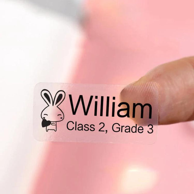 Thermal Stickers for NIIMBOT D11 Printer: Cosmetic Labels clear waterproof synthetic label with name William held between fingers