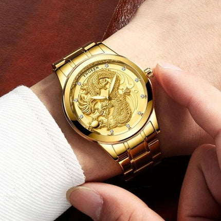 FNGEEN Luminous Couple's Watch with Elegant Gold Design shown on wrist, gold luminous dial with dragon motif and stainless steel bracelet