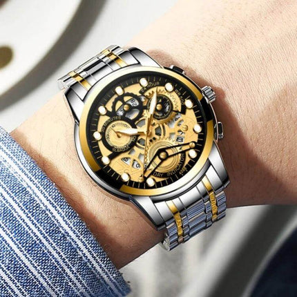 FNGEEN Men's Waterproof Luminous Quartz Watch For Daily Use on wrist showing luminous gold-skeleton dial and stainless steel bracelet