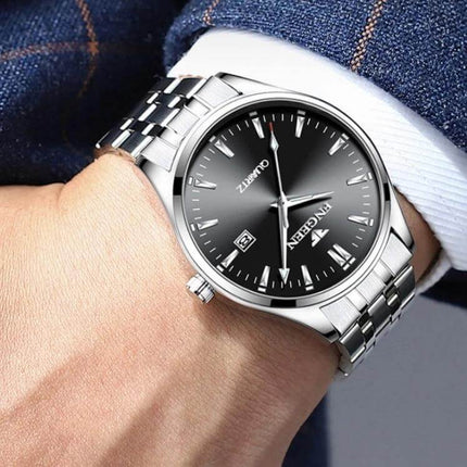 FNGEEN Men's Luminous Calendar Watch for Everyday Use stainless steel silver watch on wrist with luminous hands and calendar