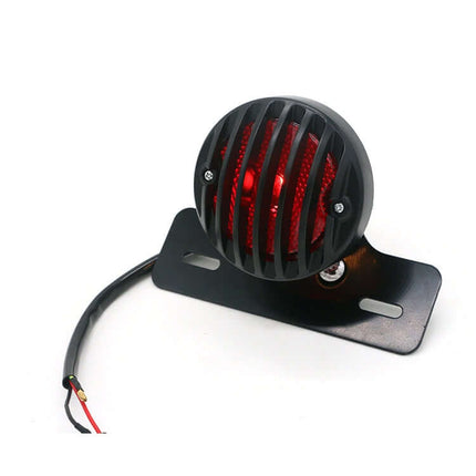 Retro Motorcycle Tail Light with Red Brake Indicator — metal shell, PC lens, red brake light on black grille mount for motorcycles, ATVs and scooters