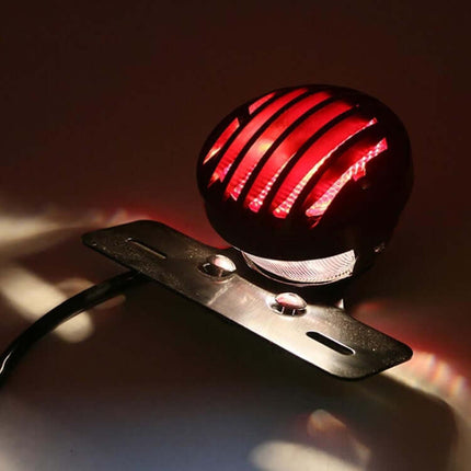 Retro Motorcycle Tail Light with Red Brake Indicator on metal shell and PC lens, glowing red vintage motorcycle tail brake light