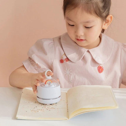 Mini Handheld Wireless Vacuum Cleaner for Desktops and Tables, Multiple Colors - child using compact cordless tabletop vacuum to clean pencil shavings