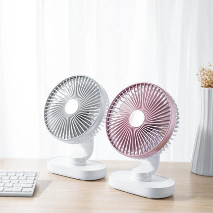 Quiet Automatic Shaking Desktop Fan for Home and Office Use on a desk showing two compact fans, white and pink, ideal for quiet home office cooling