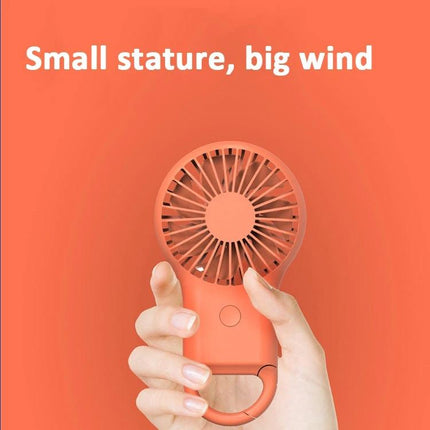 Compact Portable Handheld Mini Fan with USB Charging and LED Lights in coral held by hand, lightweight pocket-sized cooling device with carabiner