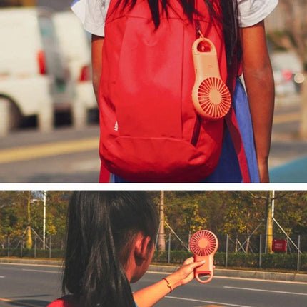 Compact Portable Handheld Mini Fan with USB Charging and LED Lights attached to backpack and held outdoors for on-the-go cooling